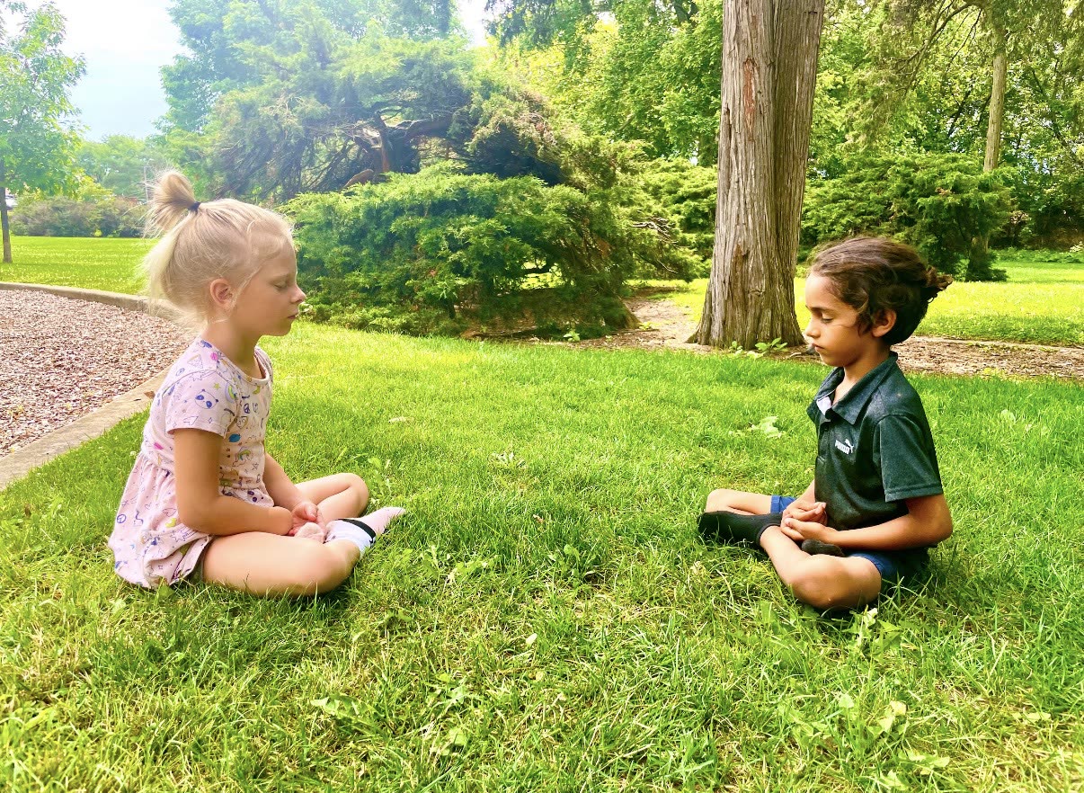 Children learning outdoors on the grass