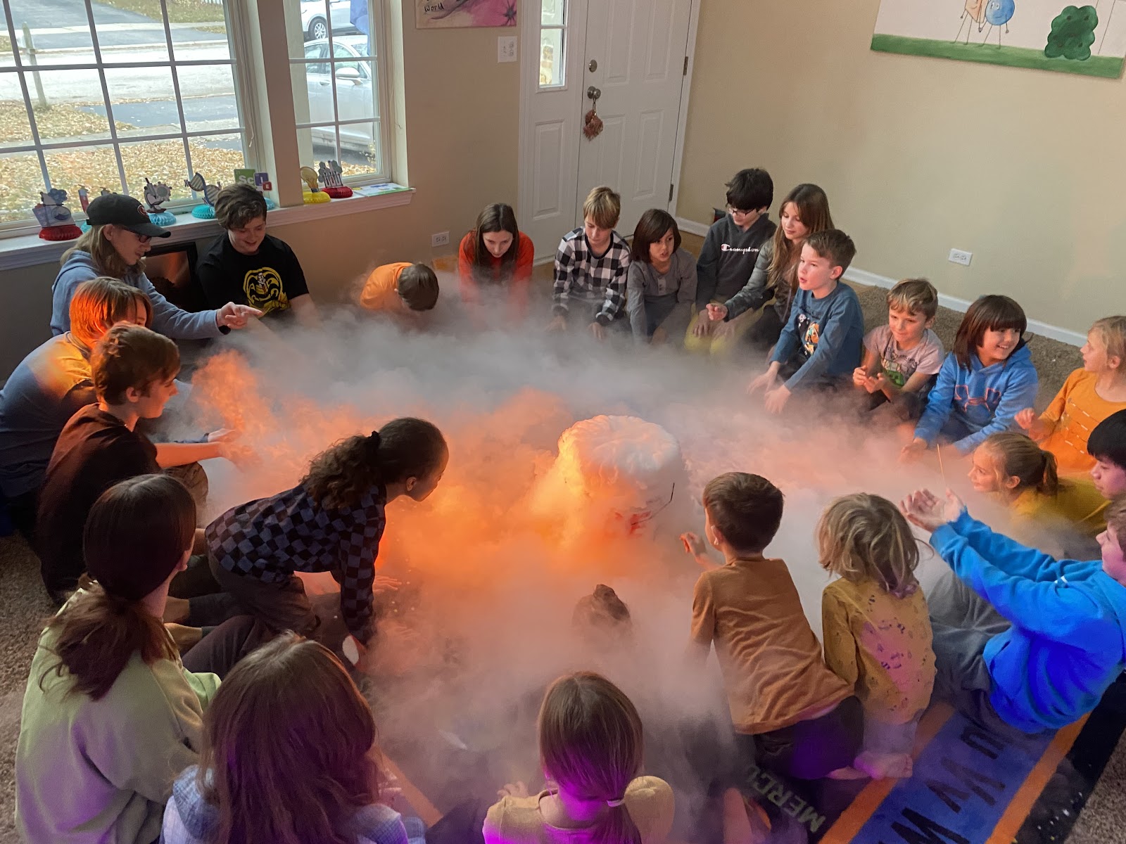 Children gathered around a dry-ice science demonstration